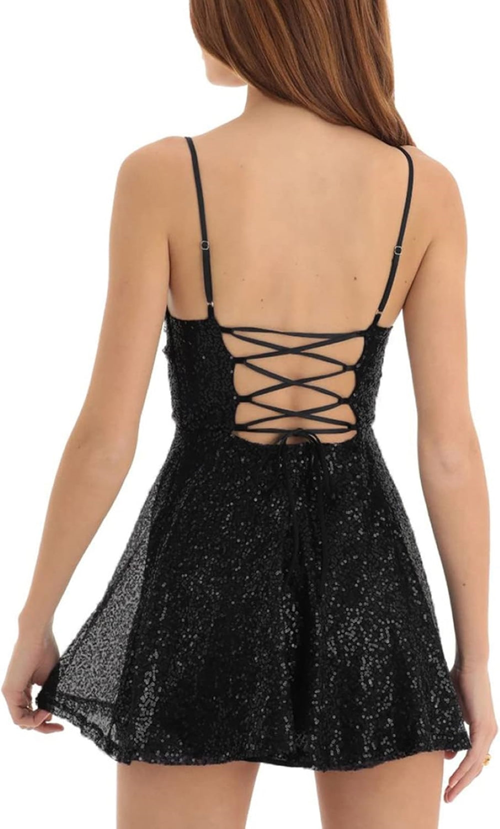 A model wearing a black sequined mini dress with thin shoulder straps and a crisscross open back