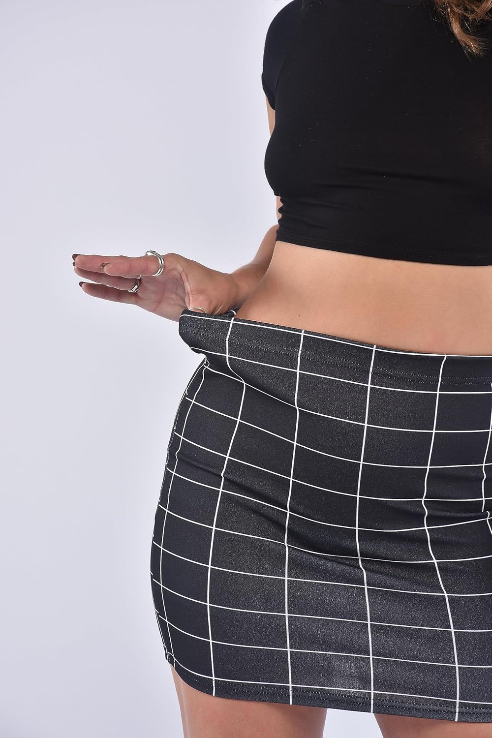 Black-Grid mini skirt with white grid lines, elastic waistband, and form-fitting design. Simple geometric pattern and smooth fabric for casual wear
