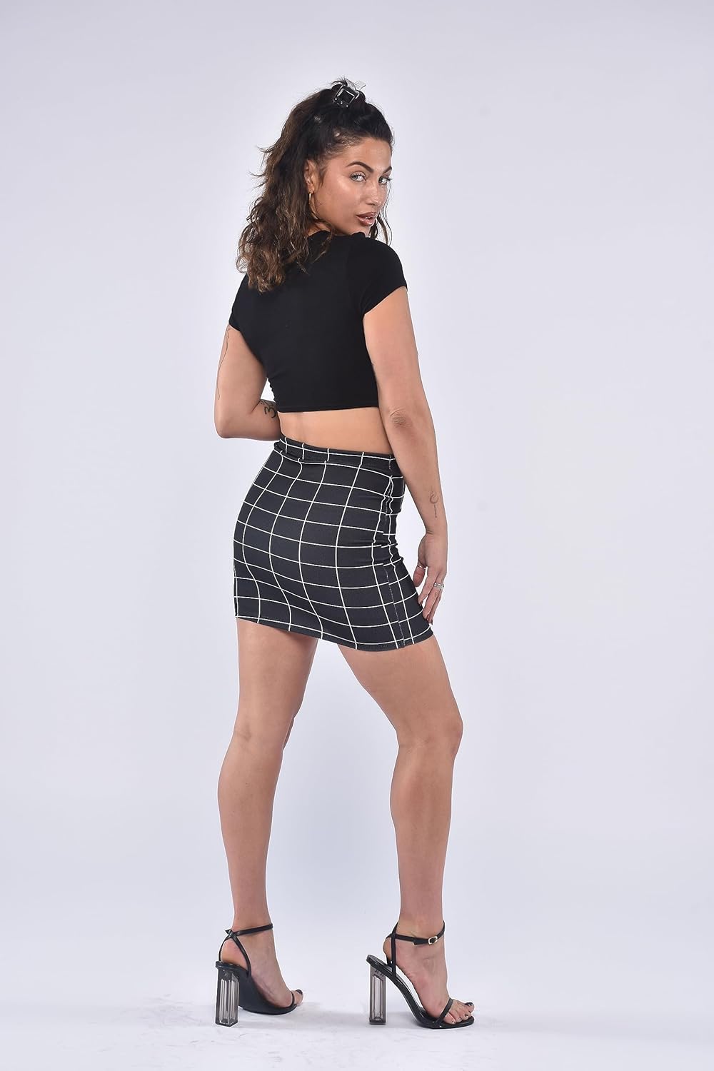 Black-Grid mini skirt with white grid lines, elastic waistband, and form-fitting design. Simple geometric pattern and smooth fabric for casual wear