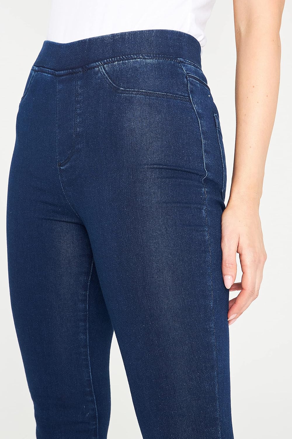 Dark blue skinny jeans with elastic waistband and back pockets.