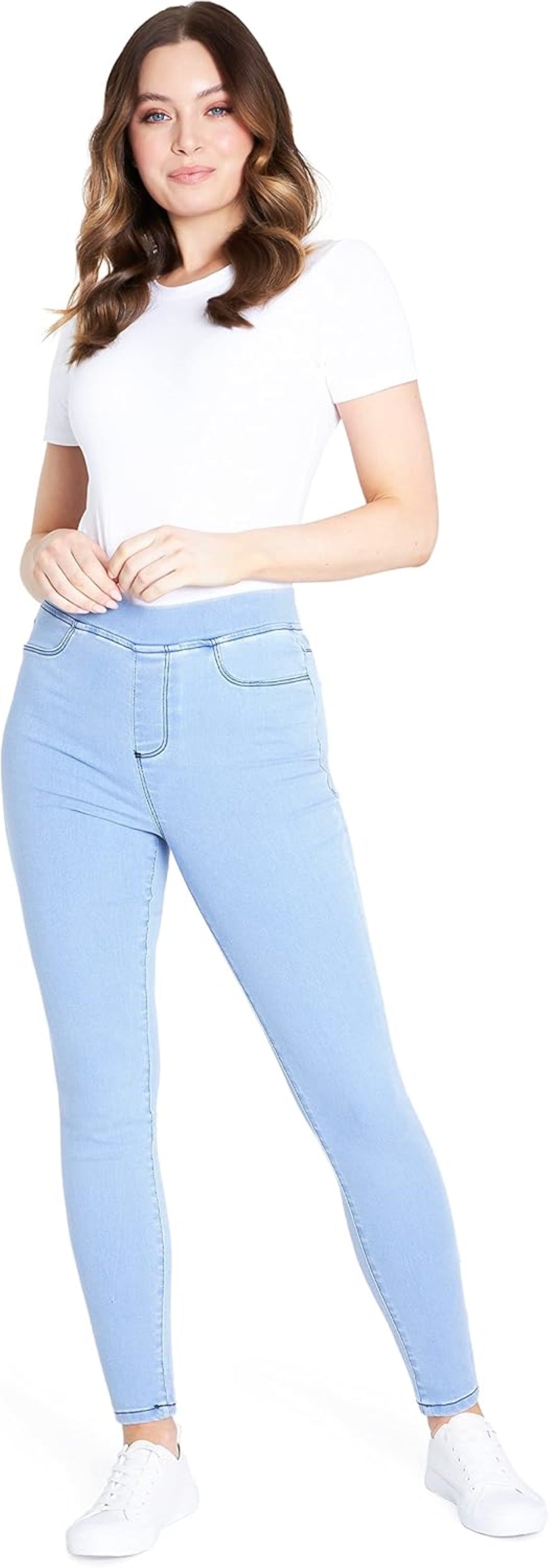 Light blue stretchy denim jegging with high waistband and functional pockets, paired with white sneakers.