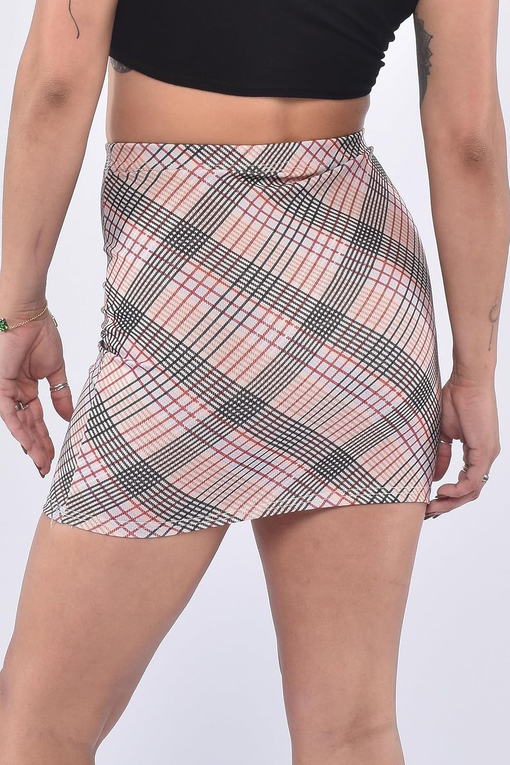 Nude mini skirt with elastic waistband and checkered pattern. Casual, form-fitting design with smooth fabric for everyday wear