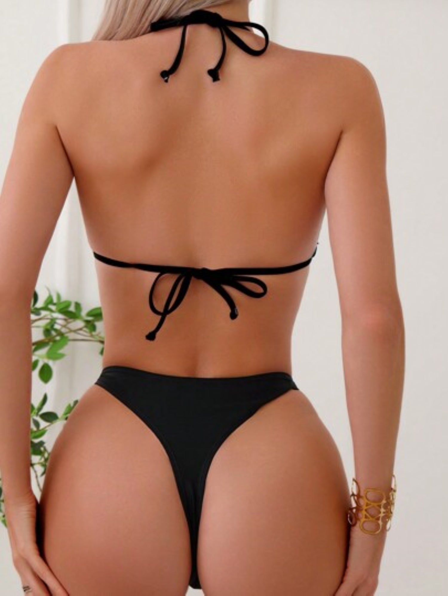 Black bikini worn by a Model on a white background