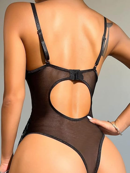 Rear view of a model wearing a sheer black bodysuit with a large open-back cutout and thin shoulder straps, photographed against a plain light gray studio background.