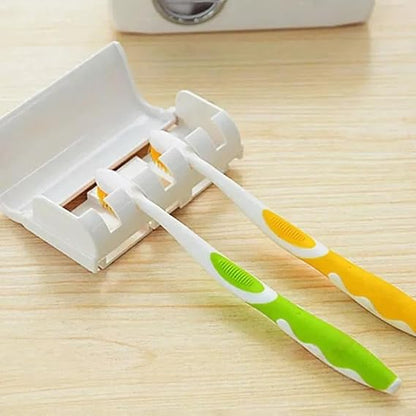 Universal toothpaste dispenser with toothbrush holder for electric and manual brushes