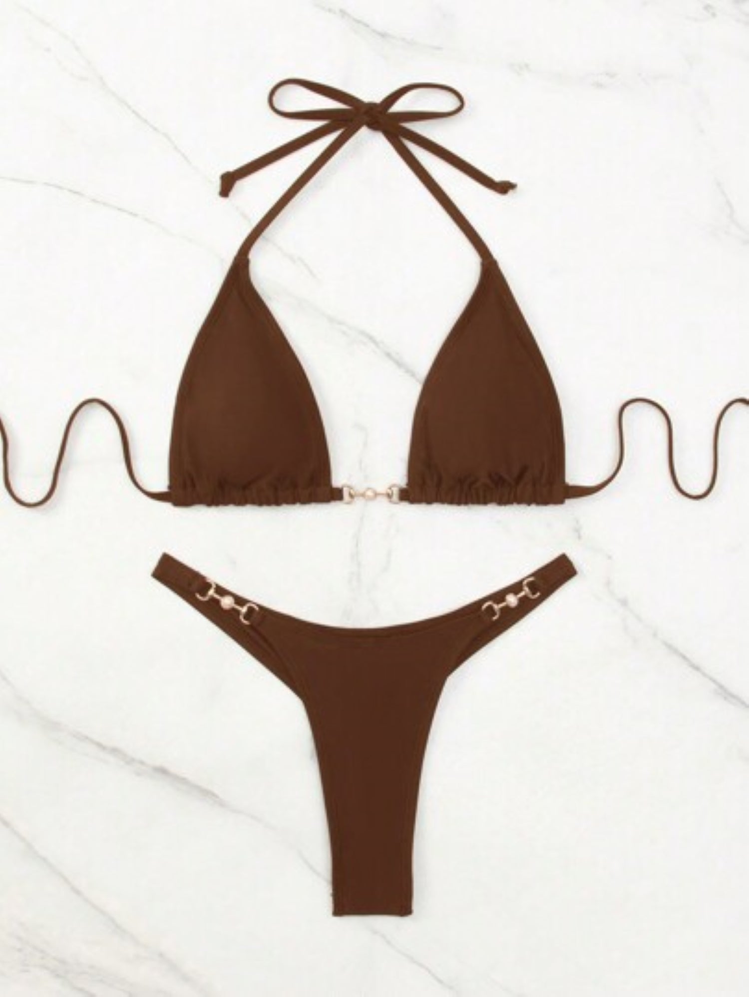 Brown bikini set with gold accents on a white background