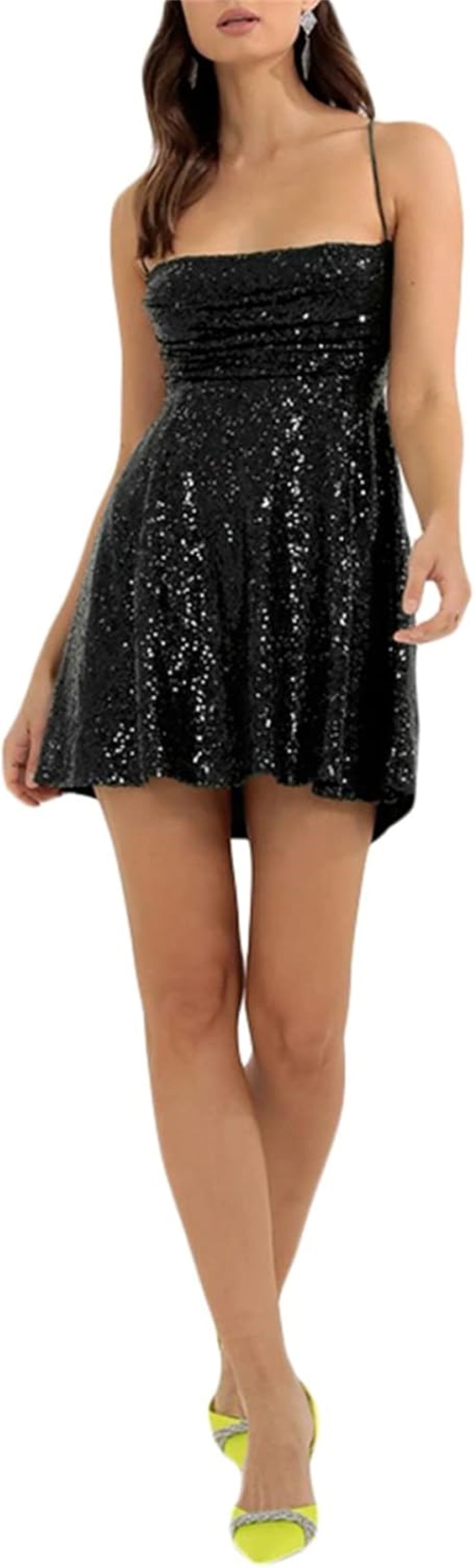 Black sequin mini dress with a sweetheart neckline, thin spaghetti straps, fitted bodice, and flared skirt. Paired with statement earrings. Shown against a plain background.
