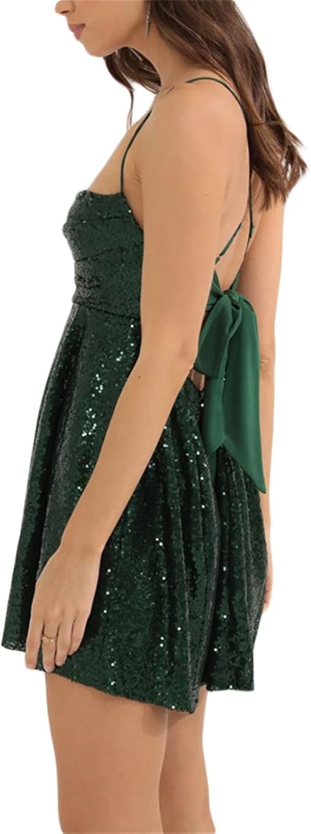 dark-Green mini dress with a sweetheart neckline, thin spaghetti straps, fitted bodice, and flared skirt. Features a crisscross back with a bow detail. Paired with a ring on the finger. Shown against a plain background.