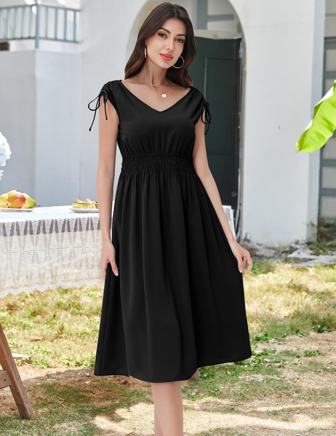 Black midi dress with a V-neckline, cap sleeves, and a shirred waist.