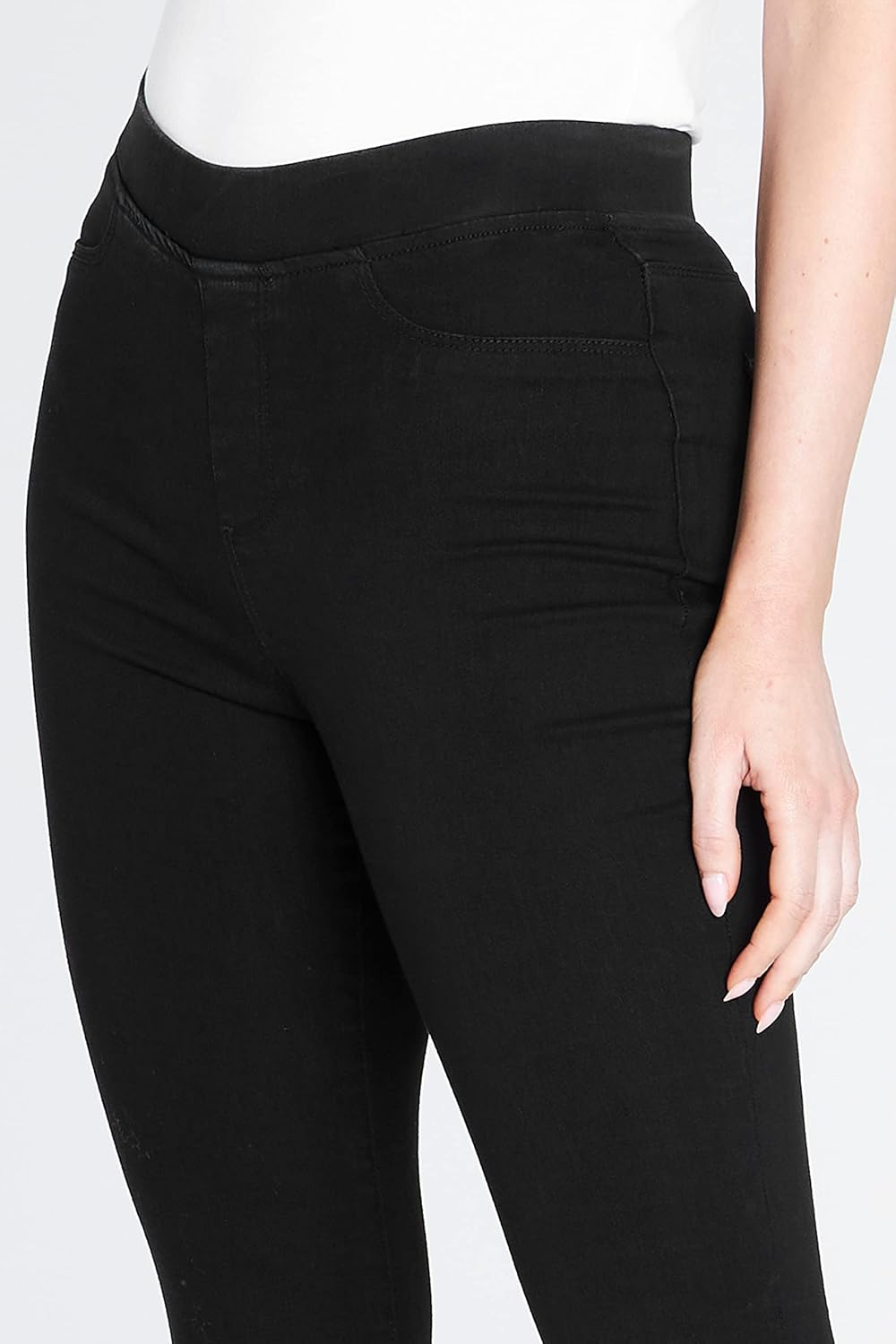 Black high-waisted stretchy leggings with functional back pockets, paired with a white short-sleeved shirt