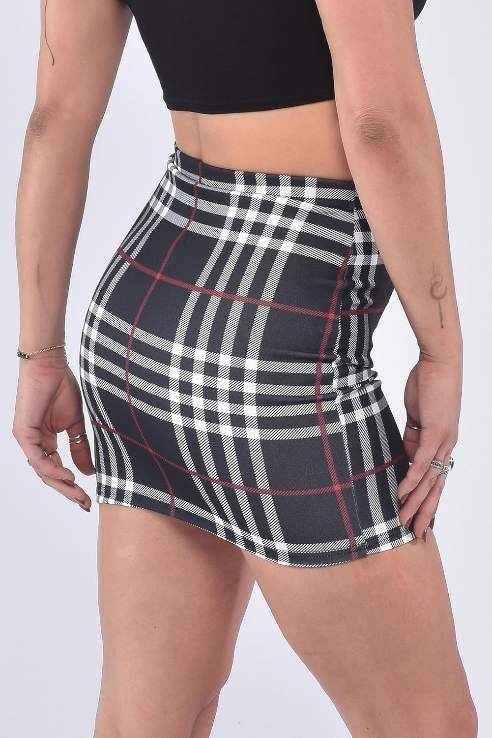 Black-Check plaid mini skirt with elastic waistband and subtle red accents. Classic checkered pattern, form-fitting design, and smooth fabric for comfortable wear.