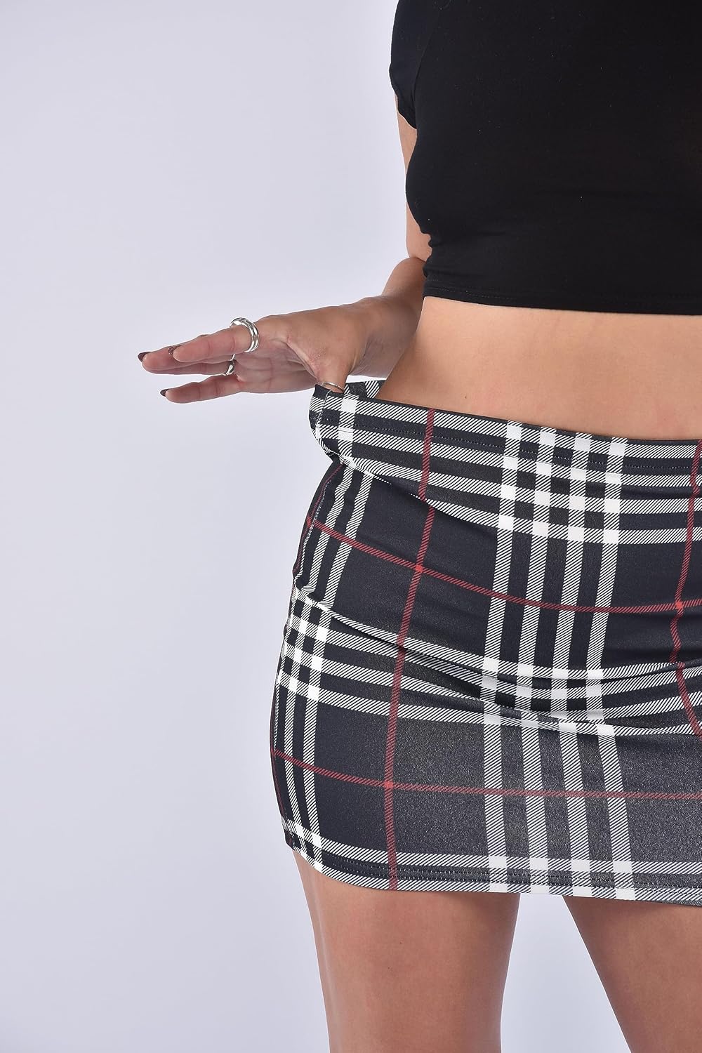 Black-Check plaid mini skirt with elastic waistband and subtle red accents. Classic checkered pattern, form-fitting design, and smooth fabric for comfortable wear.