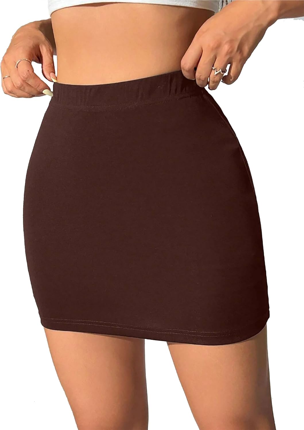 Chocolate mini skirt with form-fitting design and smooth fabric. Casual and elegant style with a solid color for versatile wear.