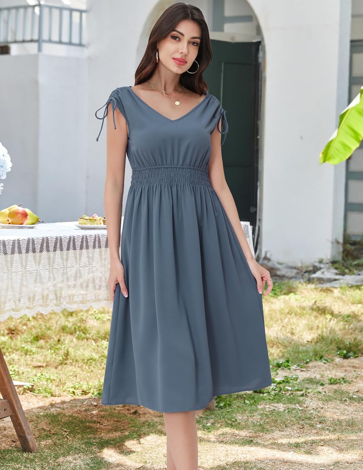 Denim-Blue dress with a V-neckline, cap sleeves, and a shirred waist.