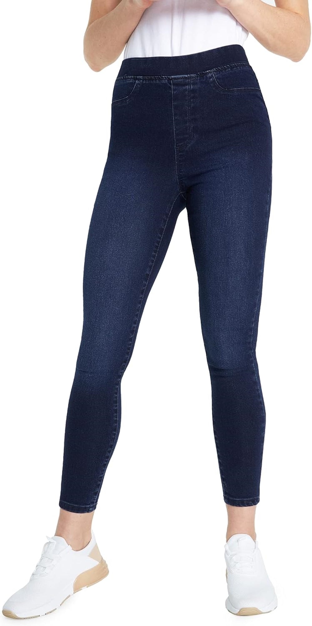 Woman wearing Indigo-Blues skinny jeans with a high waistband and white sneakers.