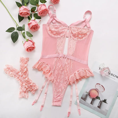Pink lace lingerie bodysuit with floral lace panels, adjustable shoulder straps, ruffled hem, matching garter belt, and lace trim. Feminine design with a keyhole cutout and delicate detailing.