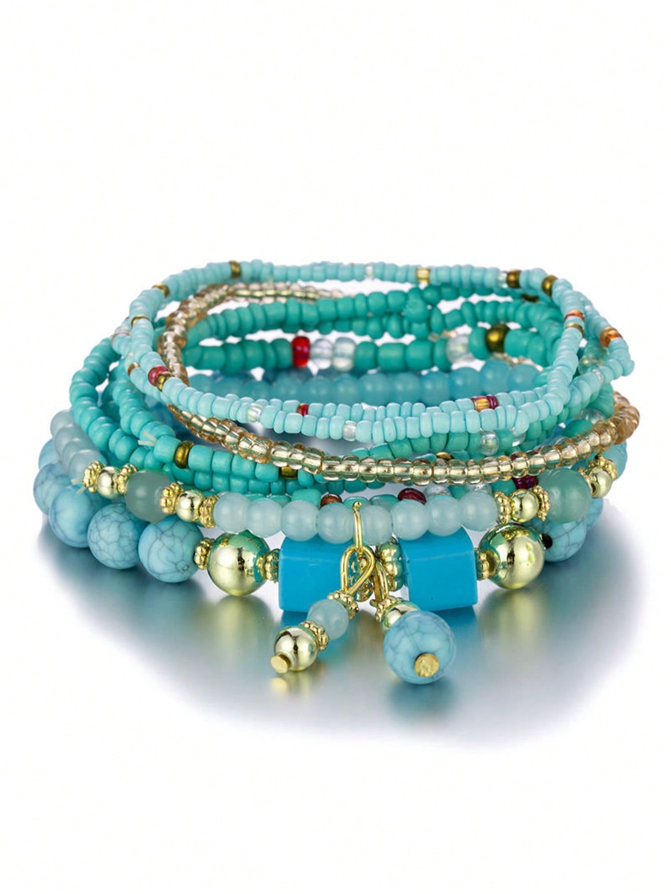 Stack of turquoise beaded bracelets with gold accents and a square turquoise pendant. Layered design with varying bead sizes and gold spacers for a colorful, bohemian look.