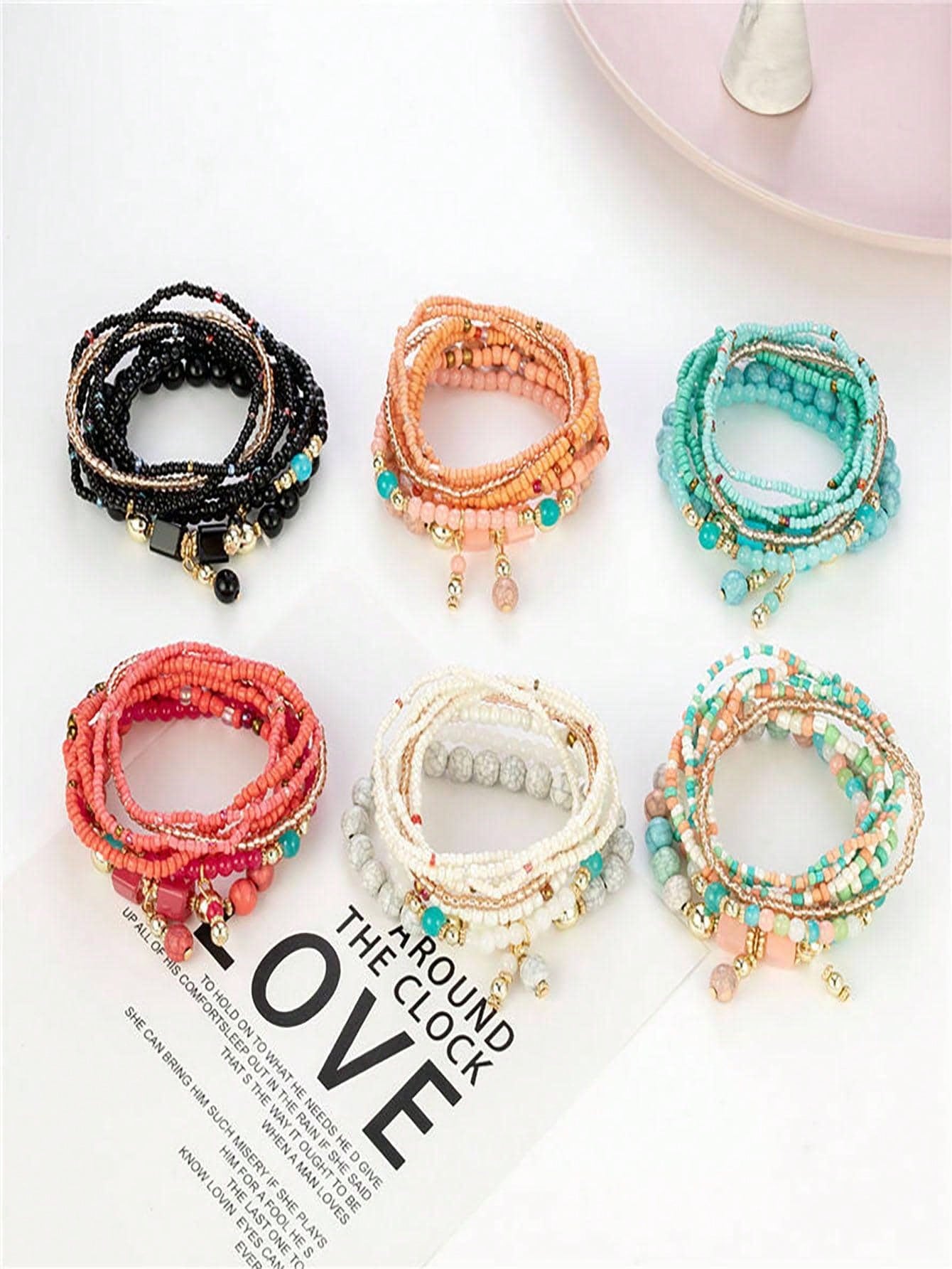 Set of six multilayer beaded bracelets in black, peach, turquoise, coral, white, and mint. Each features small beads, gold accents, and charm details for a versatile, bohemian style.