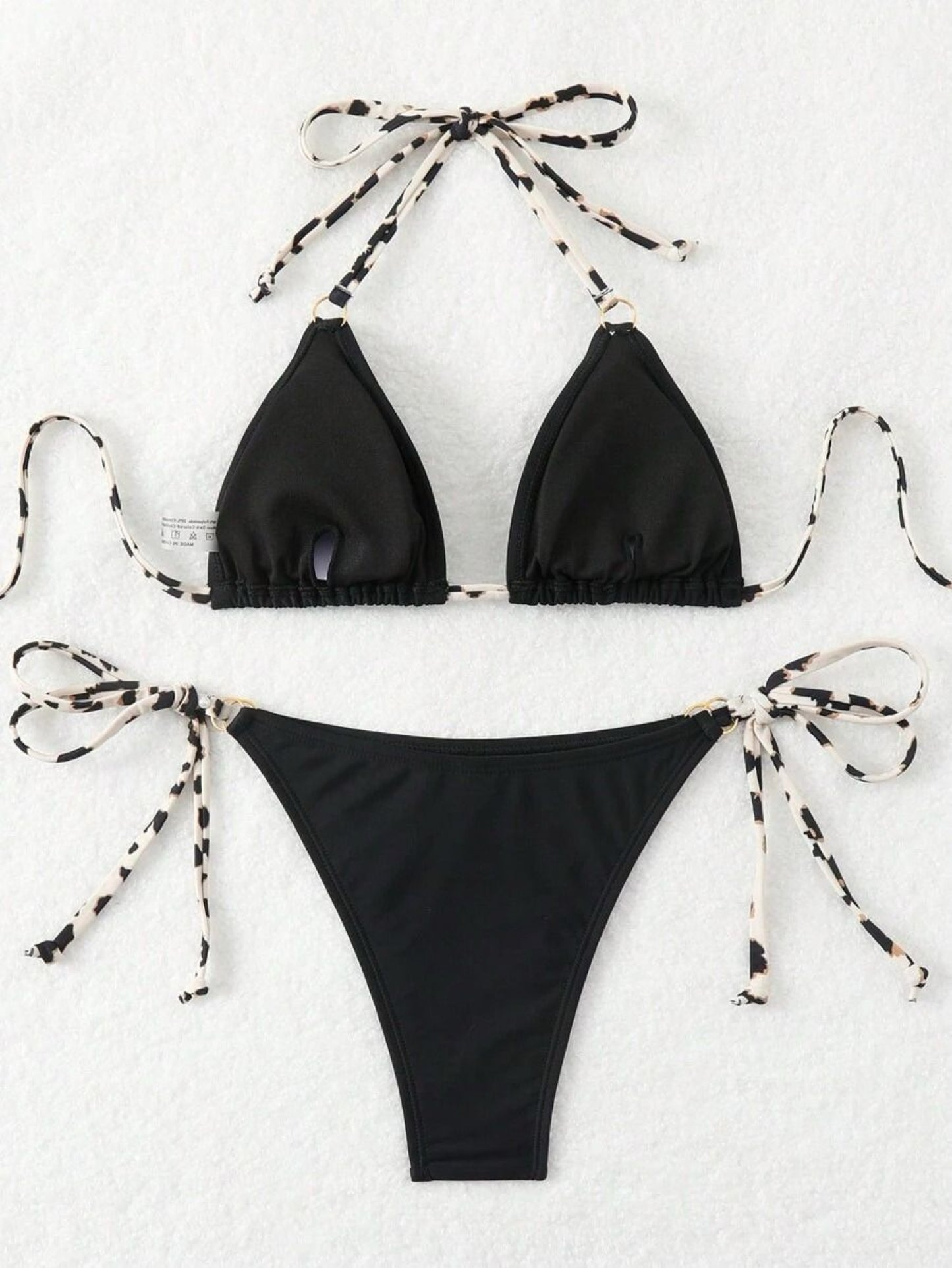 Black bikini set with multicolour tie details on a white background