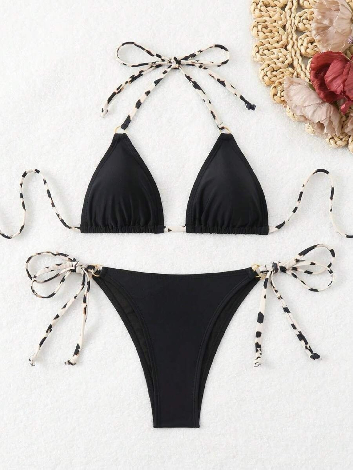Black bikini set with bow details on a white background