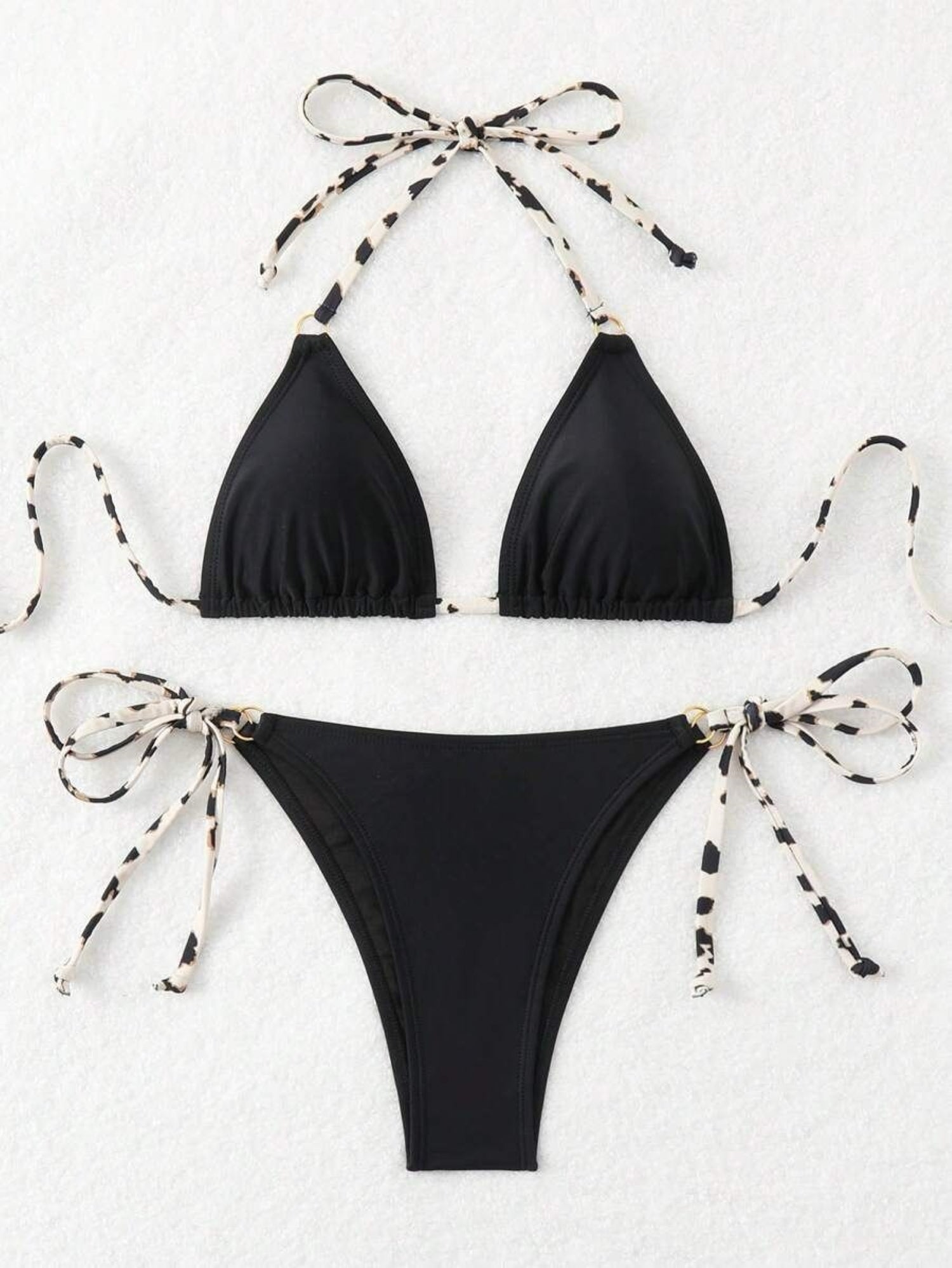 Black bikini set with bow details on a white background
